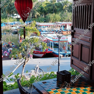 Vue sur le port de Hoi An, Vietnam, à travers la fenêtre d’un café au 1er étage